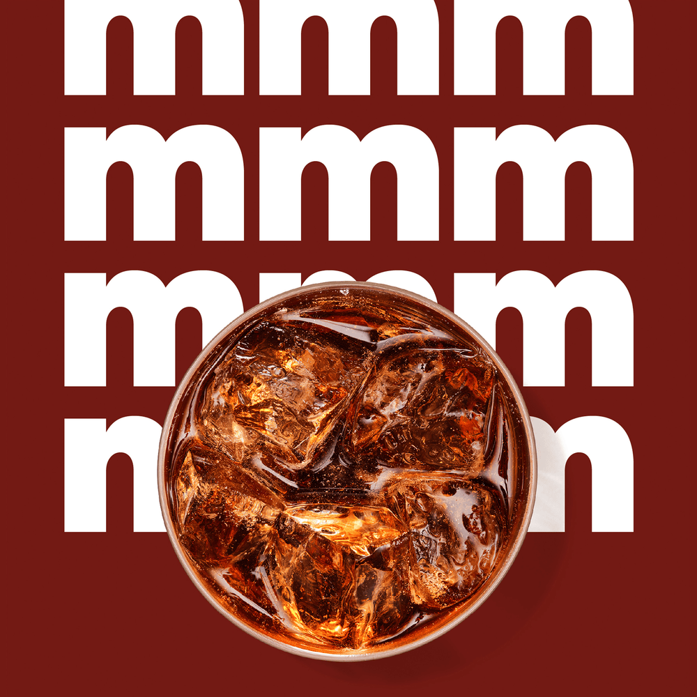 Finished Diet Cola drink with 'mmm' background