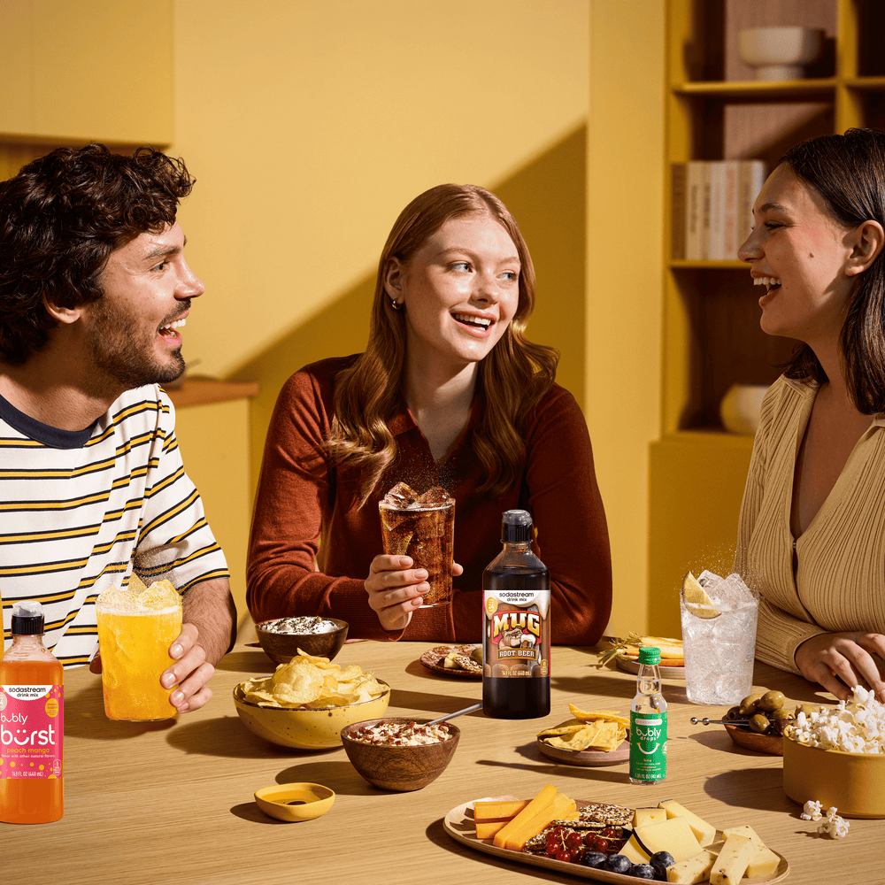 Friends enjoying Sodastream drinks, including the Sodastream Mug